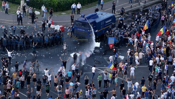 Polícia usa um canhão de água contra milhares de romenos em um protesto contra o governo na capital Bucareste, 10 de agosto de 2018. - Sputnik Brasil