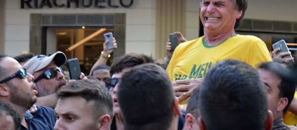 O candidato presidencial brasileiro Jair Bolsonaro reage após ser esfaqueado durante um comício em Juiz de Fora, Estado de Minas Gerais. Foto tirada em 6 de setembro de 2018. - Sputnik Brasil