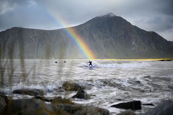 Surfista com arco-íris em fundo no norte da Noruega. - Sputnik Brasil