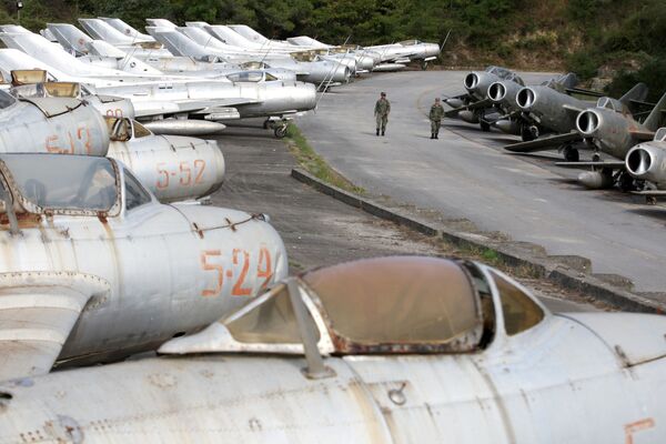 Militares da Força Aérea albanesa caminhando ao lado de caças MiG na base aérea de Kucove - Sputnik Brasil