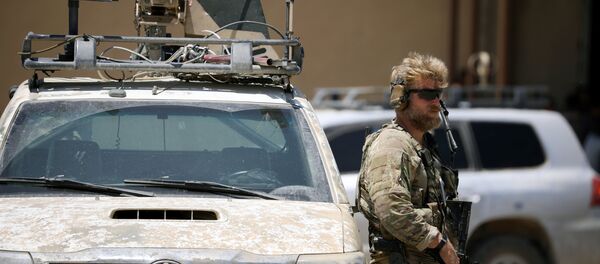 Soldados dos EUA segura uma arma enquanto mantém a guarda de um veículo blindado. A escolta faz parte da comitiva que acompanhou o enviado norte-americano para a coalizão internacional contra o Daesh, Brett McGurk, durante vistia à cidade de Tabqa, na Síria. - Sputnik Brasil