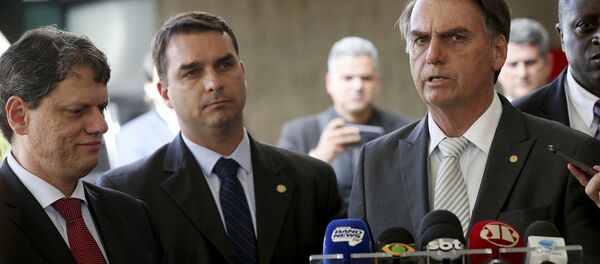 Jair Bolsonaro com o filho Flávio e o novo ministro da Infraestrutura Tarcisio Gomes de Freitas - Sputnik Brasil