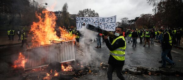 Manifestantes construir uma barricada durante um protesto de coletes amarelos (Gilets jaunes) contra o aumento dos preços do petróleo e os custos de vida, em 1 de dezembro de 2018 em Paris. - Sputnik Brasil