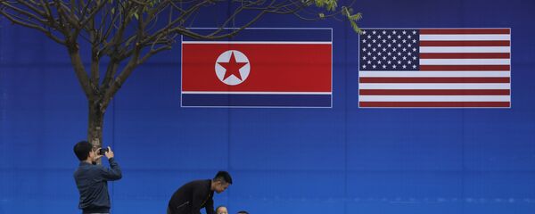 Pessoas tiram fotos em frente à bandeira da Coreia do Norte e dos EUA, em Hanói, Vietnã, 24 de fevereiro de 2019 - Sputnik Brasil