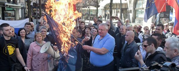 Vojislav Seselj, líder do Partido Radical Sérvio, segura bandeira da OTAN em chamas durante manifestação em Belgrado Vojislav Seselj, líder do Partido Radical Sérvio, segura bandeira da OTAN em chamas durante manifestação em Belgrado - Sputnik Brasil