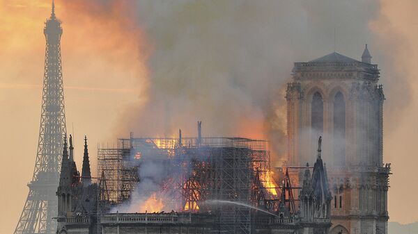 Chamas e fumaça sobem do incêndio após a queda da torre na catedral de Notre Dame em Paris, 15 de abril de 2019 - Sputnik Brasil