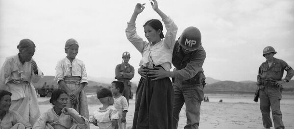 Um militar estadunidense revisa uma mulher coreana procurando armamentos escondidos (foto de arquivo) - Sputnik Brasil