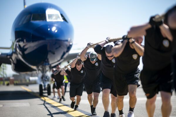 Participantes da competição anual Plane Pull puxando um JetBlue A320 no Aeroporto Internacional John F. Kennedy, em Nova York, EUA - Sputnik Brasil