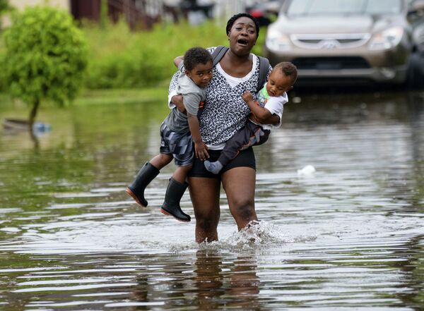 Mãe carregando seus filhos durante a inundação em Nova Orleans (EUA) - Sputnik Brasil