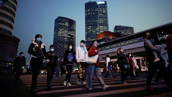 Pessoas usando máscaras faciais para se protegerem do coronavírus no centro de Xangai, China, 17 de março de 2020 - Sputnik Brasil