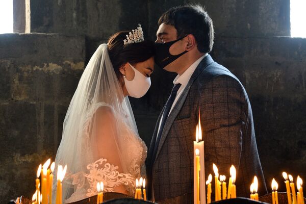 Casal se beija durante sua cerimônia de casamento usando máscaras no vilarejo de Saghmosavan, na Armênia - Sputnik Brasil