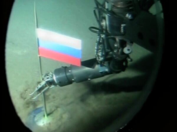 Um operador do minissubmarino russo pondo a cápsula com a bandeira russa durante o segundo mergulho no oceano Ártico debaixo dos gelos do polo Norte. 3 de agosto de 2007 - Sputnik Brasil