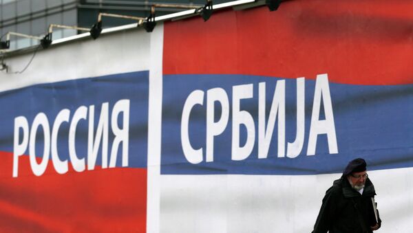 Um homem passa perto da cartaz com inscrições Rússia e Sérvia, 17 de outubro de 2014 - Sputnik Brasil