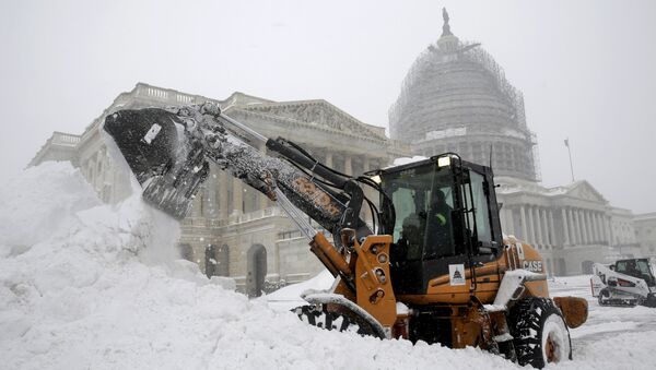 A Capitol Hill employee uses a heavy earth moving machine to clear snow during a winter storm in Washington January 23, 2016. A winter storm dumped nearly 2 feet (58 cm) of snow on the suburbs of Washington, D.C., on Saturday before moving on to Philadelphia and New York, paralyzing road, rail and airline travel along the U.S. East Coas - Sputnik Brasil