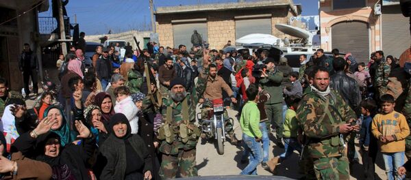 Residents of Nubul and al-Zahraa, along with forces loyal to Syria's President Bashar al-Assad, celebrate after the siege of their towns was broken, northern Aleppo countryside, Syria, in this handout picture provided by SANA on February 4, 2016 - Sputnik Brasil