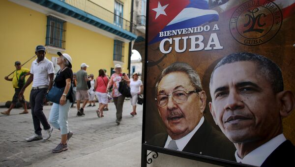 Tourists pass by images of U.S. President Barack Obama and Cuban President Raul Castro in a banner that reads Welcome to Cuba at the entrance of a restaurant in downtown Havana, March 17, 2016. - Sputnik Brasil