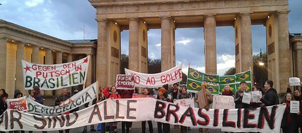 Na Alemanha, brasileiros se reúnem diante da Porta de Brandemburgo, em Berlim, estendendo cartazes com os dizeres “Não vai ter golpe” e “Pela Democracia” - Sputnik Brasil