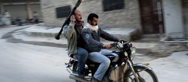 Supporters of the Free Syrian Army ride a motorcycle with a rocket-propelled grenade in Kafar Taharim, Syria. - Sputnik Brasil