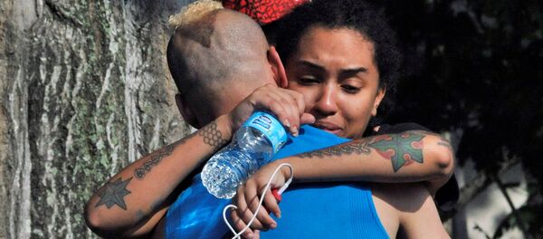 Amigos e familiares de vítimas em Orlando perto do clube Pulse após o tiroteio. 12 de junho, 2016 - Sputnik Brasil