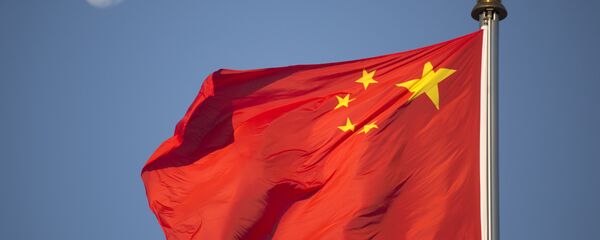 he moon sets above a Chinese flag flying over Tiananmen Square after a flag raising ceremony on National Day, the 66th anniversary of the founding of the People's Republic of China, in Beijing, Thursday, Oct. 1, 2015 - Sputnik Brasil