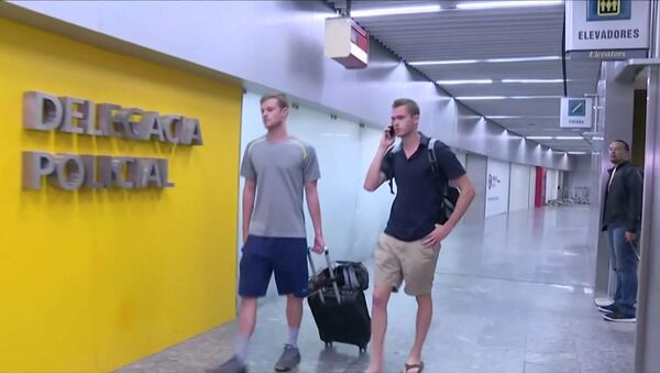 U.S. Olympic swimmers Gunnar Bentz and Jack Conger walk to the airport police station office at Rio's international airport in this still frame taken from video dated August 17, 2016, in Rio De Janeiro, Brazil. - Sputnik Brasil