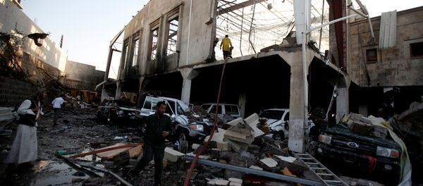 People stand at the site of an airstrike which witnesses said was by Saudi-led coalition aircraft on mourners at a hall where a wake for the father of Jalal al-Roweishan, the interior minister in the Houthi-dominated Yemeni government, was being held, in Sanaa, Yemen October 8, 2016 - Sputnik Brasil