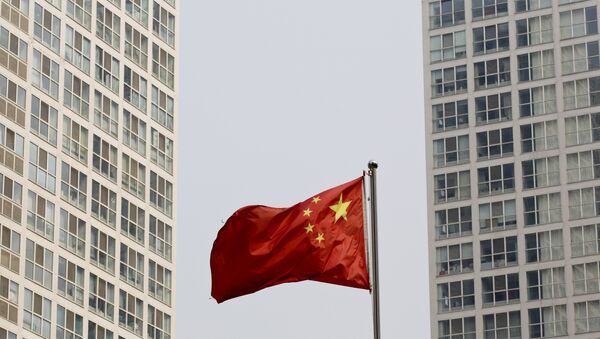 Uma bandeira nacional chinesa vibra no vento entre um complexo residential de grande altura e do escritório em Beijing, China (foto arquiva) - Sputnik Brasil