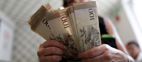 Uma funcionária da caixa está contando bolívares, moeda nacional venezuelana, em um restaurante na capital - Sputnik Brasil