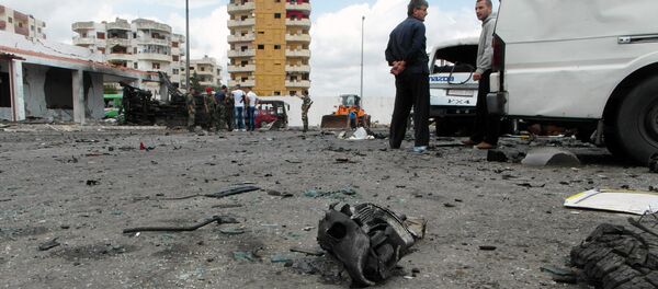 Syrians gather at the scene of multiple bombings in the the city of Tartus northwest of Damascus. File photo - Sputnik Brasil