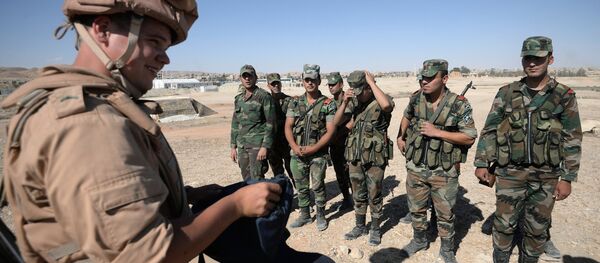 A Russian serviceman, left, trains Syrian soldiers to search and detect explosive devices in Palmyra. File photo - Sputnik Brasil