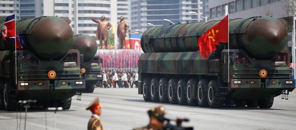 Missiles are driven past the stand with North Korean leader Kim Jong Un and other high ranking officials during a military parade marking the 105th birth anniversary of country's founding father Kim Il Sung, in Pyongyang April 15, 2017 - Sputnik Brasil