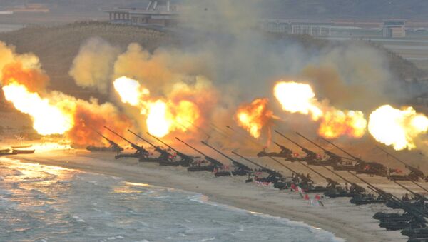 Artillery pieces are seen being fired during a military drill at an unknown location, in this undated photo released by North Korea's Korean Central News Agency (KCNA) on March 25, 2016 - Sputnik Brasil