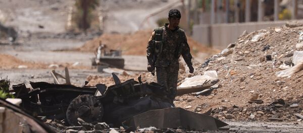Combatente das Forças Democráticas da Síria (FDS) em uma rua de Tabqa, na província de Raqqa, após retomada do controle sobre a cidade então dominada pelo Daesh Combatente das Forças Democráticas da Síria (FDS) em uma rua de Tabqa, na província de Raqqa, após retomada do controle sobre a cidade então dominada pelo Daesh - Sputnik Brasil