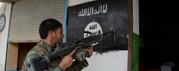 Um soldado afegão perto da bandeira do Daesh - Sputnik Brasil