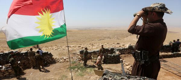 Bandeira do Curdistão e combatente curdo Peshmerga monitorando a área a partir do seu posto na linha de frente em Bashiqa - Sputnik Brasil